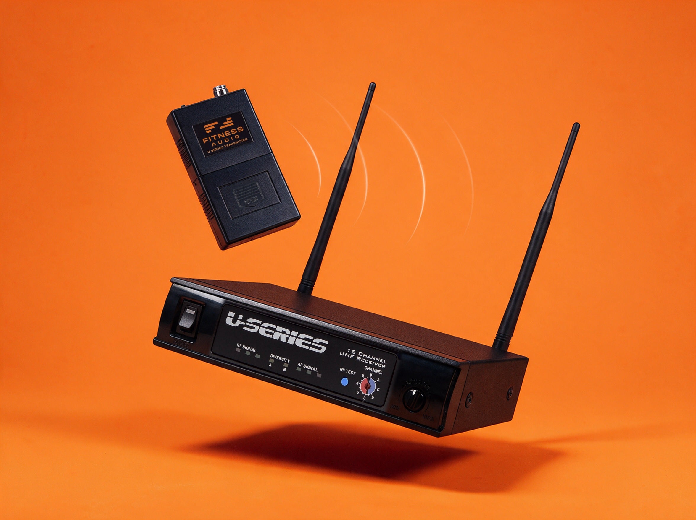 Fitness Audio U-Series UHF wireless receiver with two antennas and SM716 bodypack transmitter on an orange background