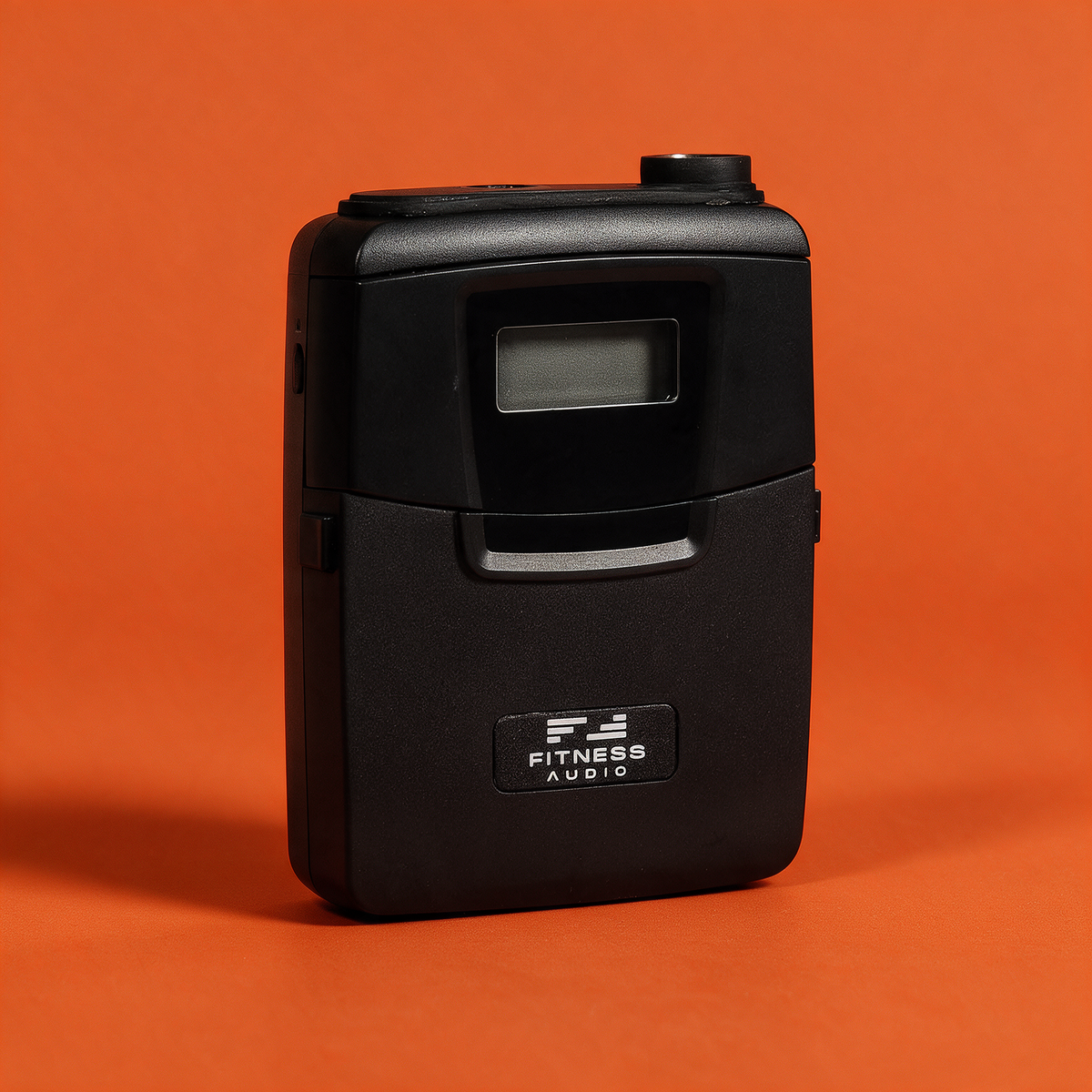 DX6-TF digital beltpack transmitter on a Fitness Audio orange backdrop