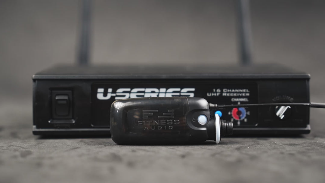 "(Upbeat instrumental music begins)"

"Narrator: The video opens showing the U-Series Transmitter and Receiver. The view shifts to the MTU8 Mini Transmitter. On-screen text appears, reading: 'Light & Compact, 28 Grams, 8 CM Long.' Next, the U-Series Channel UHF Receiver is displayed. Text highlights its features: '16 Channel Frequency Adjustment' and 'Front Facing Signal Display.' The shot widens to show the 'Additional Dual Antennas for True Diversity.' The video ends with the Fitness Audio company logo ap